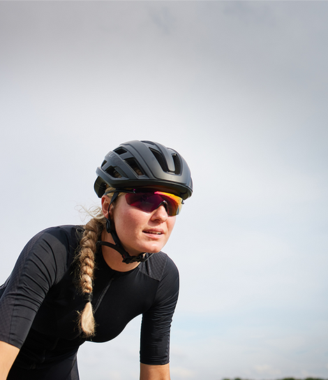 Woman cyclist wearing black G1 MIPS helmet and black jersey in sunglasses